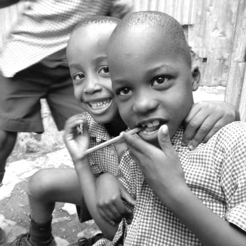 two young children from Kenya with smiles on their faces